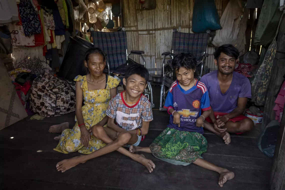 42-year-old Korng Lin (left) and 29-year-old Tun Trea (right) work hard to take care of their children, 15-year-old Den Tola (middle left) and 20-year-old Den Leak (middle right), who have mental and intellectual disabilities 