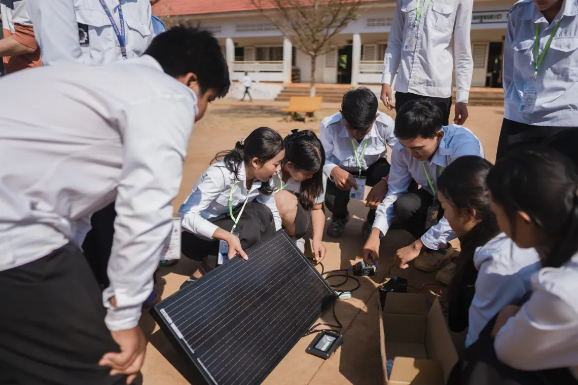 During the Youth Solar session, students get hands on practice connecting a solar panel to a light bulb.