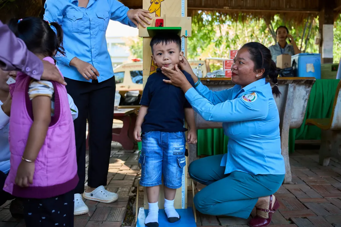 Dr. Vanh Noeum from Preah Vihear&rsquo;s Provincial Health Department measures Ann&rsquo;s height as part of the growth monitoring services provided at the mobile clinic
