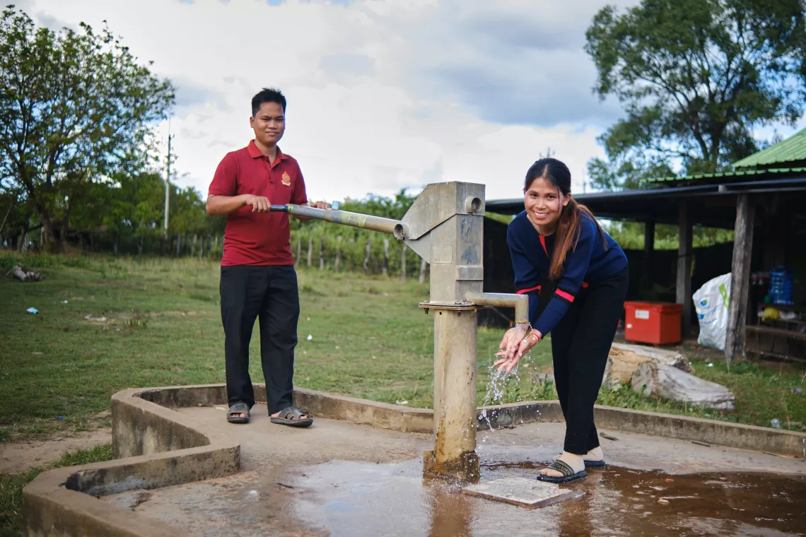 School director Bunha Kuy (left) and Grade 2 teacher Tork Tak Pon (right) say the new handwashing facilities, rehabilitated well (pictured), and automatic pump system have made it much easier for students to keep themselves healthy