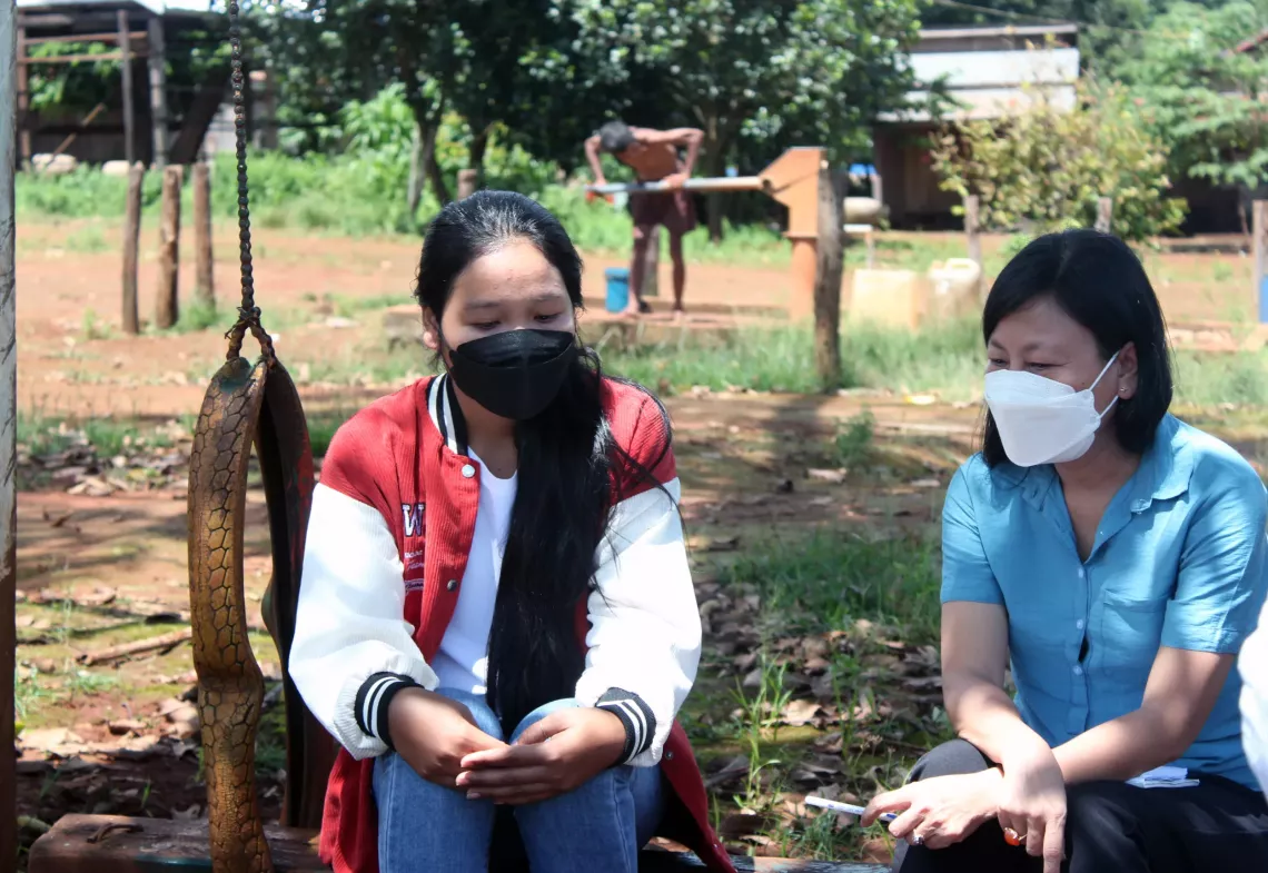 Ms. Chan Kanha (right), UNICEF Adolescent Development Officer, and Yong Nak discuss violence against children