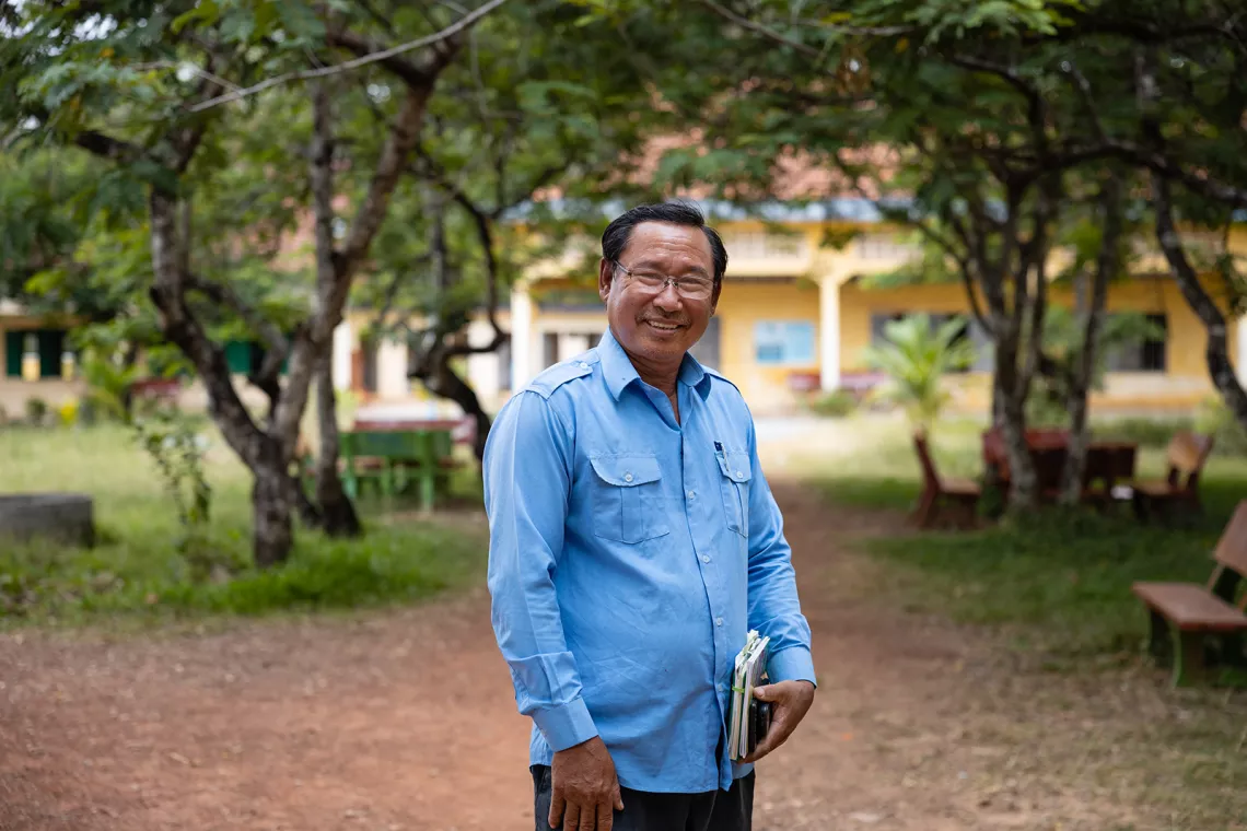 Mr Ou Heng, 55, Director of Samdech Krom Preah Ang Roneab High School, posed next to his school&rsquo;s library after sharing with UNICEF staff about how his school has been implementing Menstruation Health Management (MHM) at National Highway 3, Tramkak district, Takeo Province, Cambodia.
