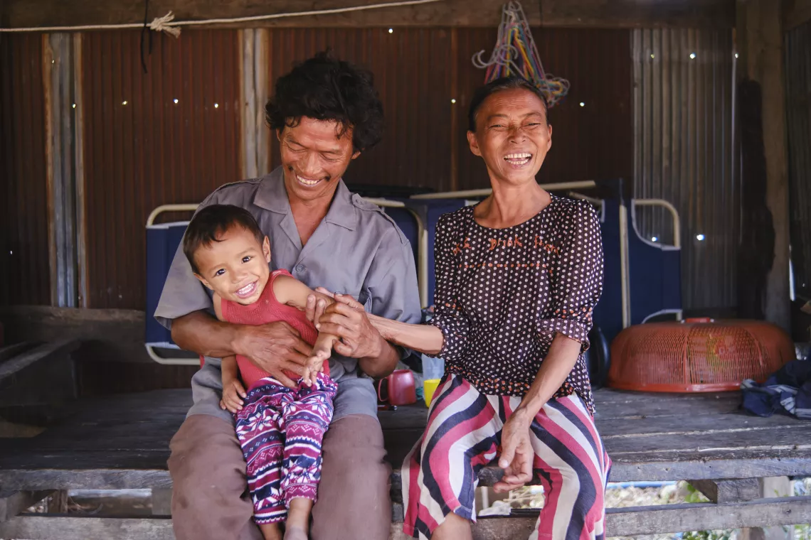 Pictured with his father, Mom Soeun, and mother, Tol Sophoeun, one-and-a-half-year-old Phanha&rsquo;s health improved dramatically after his family, one of the last in the village practising open defecation, installed a UNICEF-supported latrine at their home