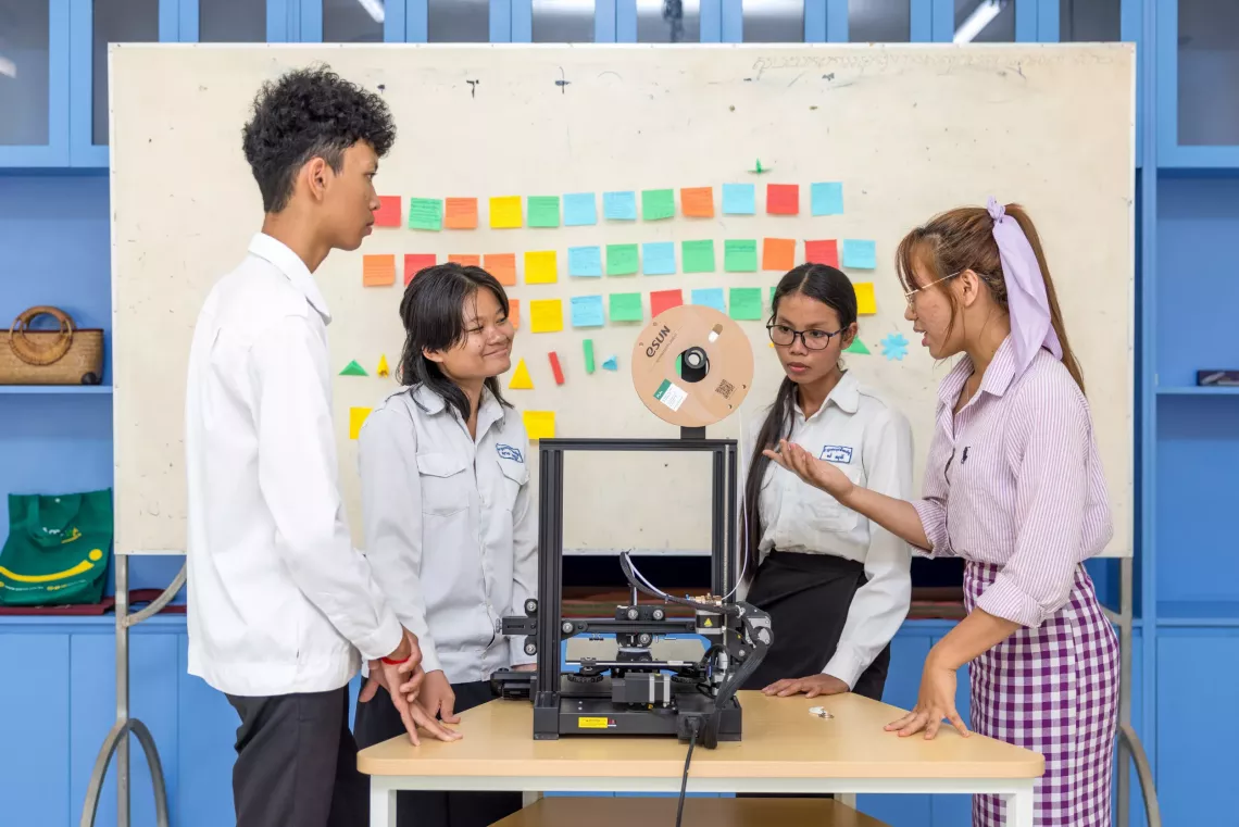 Grade 11 and 12 volunteers from Royal Crusade High School learning 3D printing with the Code for Girls team