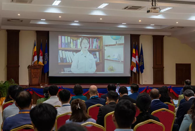 A screen showing a gril presenting