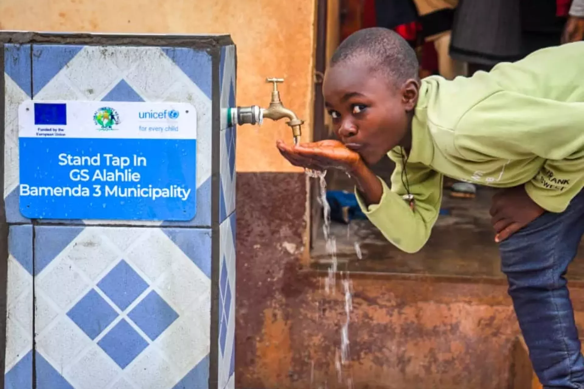 child drinking water at Alahlie