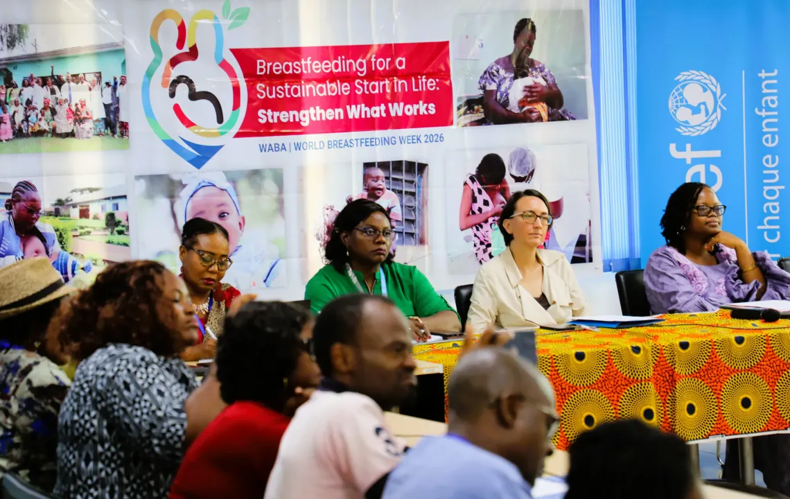 Participants attend a Media Caf&eacute; ahead of World Breastfeeding Week 2026, seated in discussion in front of campaign banners promoting breastfeeding and child nutrition.