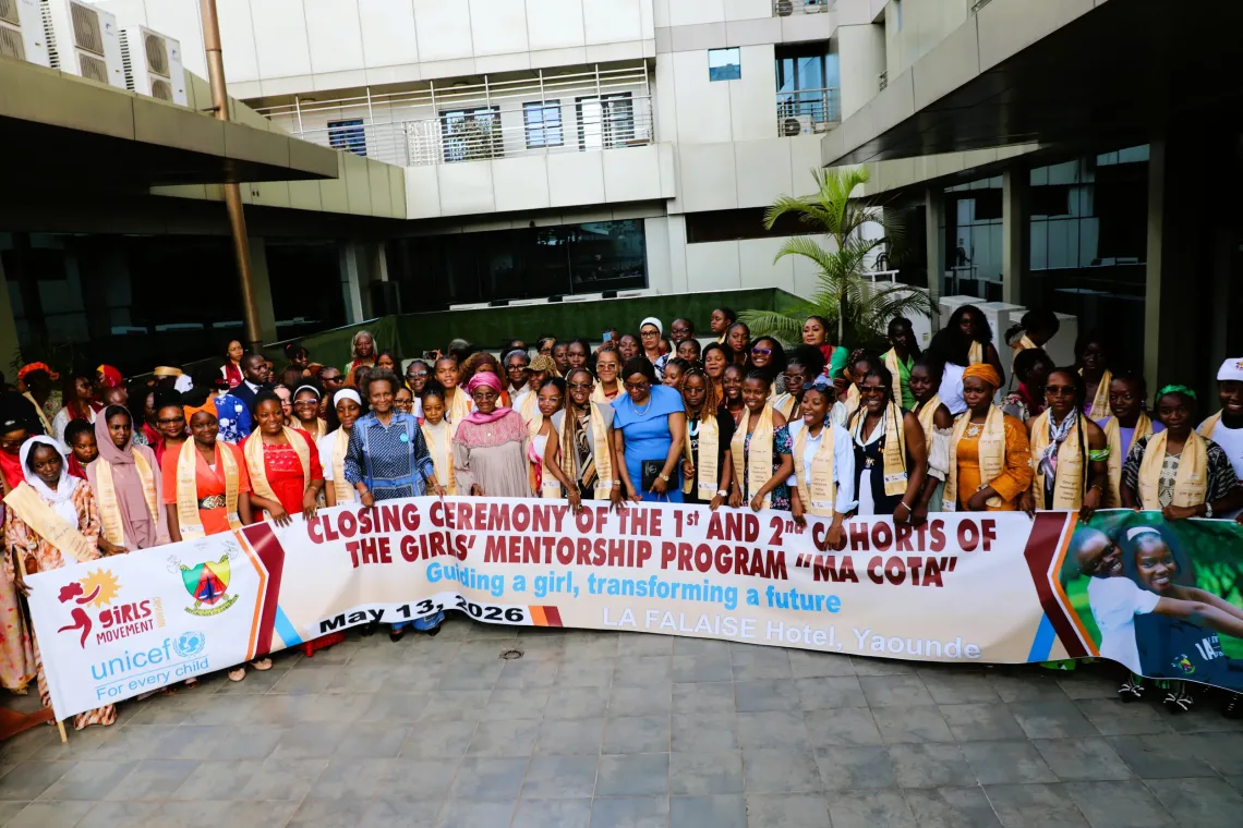 Large group holding MA COTA mentorship banner during closing ceremony in Yaound&eacute;
