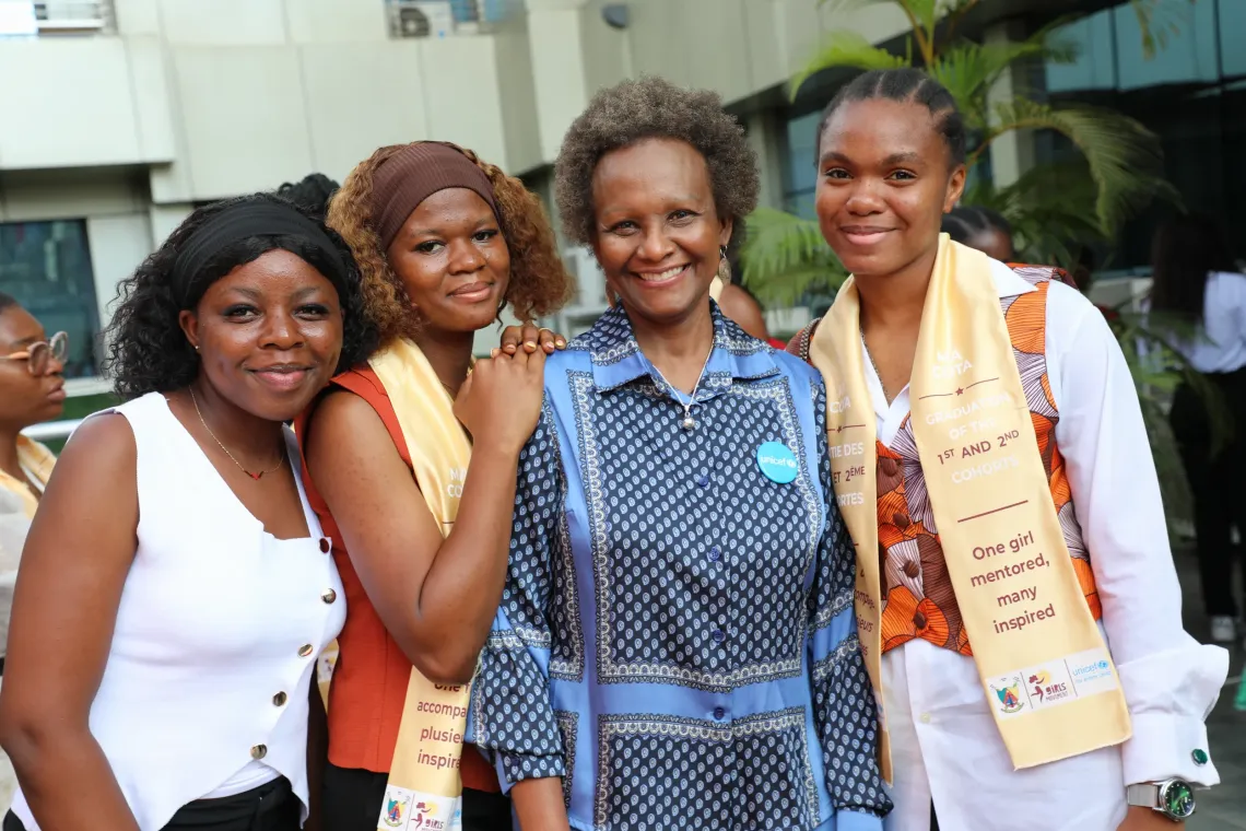 Four participants and UNICEF Representative wearing MA COTA sashes, standing together outdoors