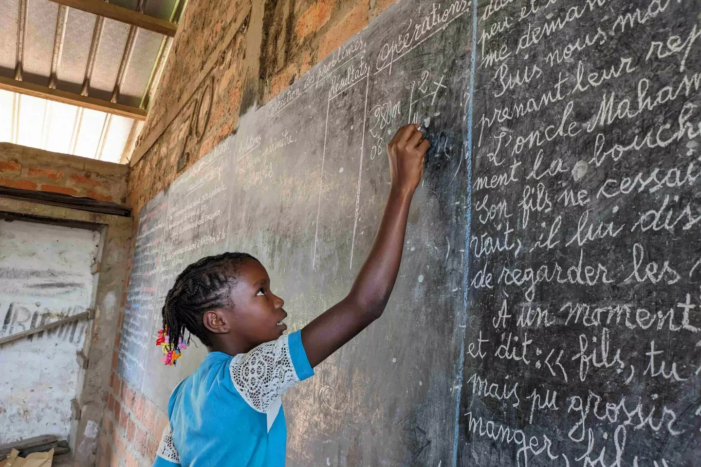  Florence Mbata, a pupil of Bokolobo Primary school, enjoys solving mathematical problems.