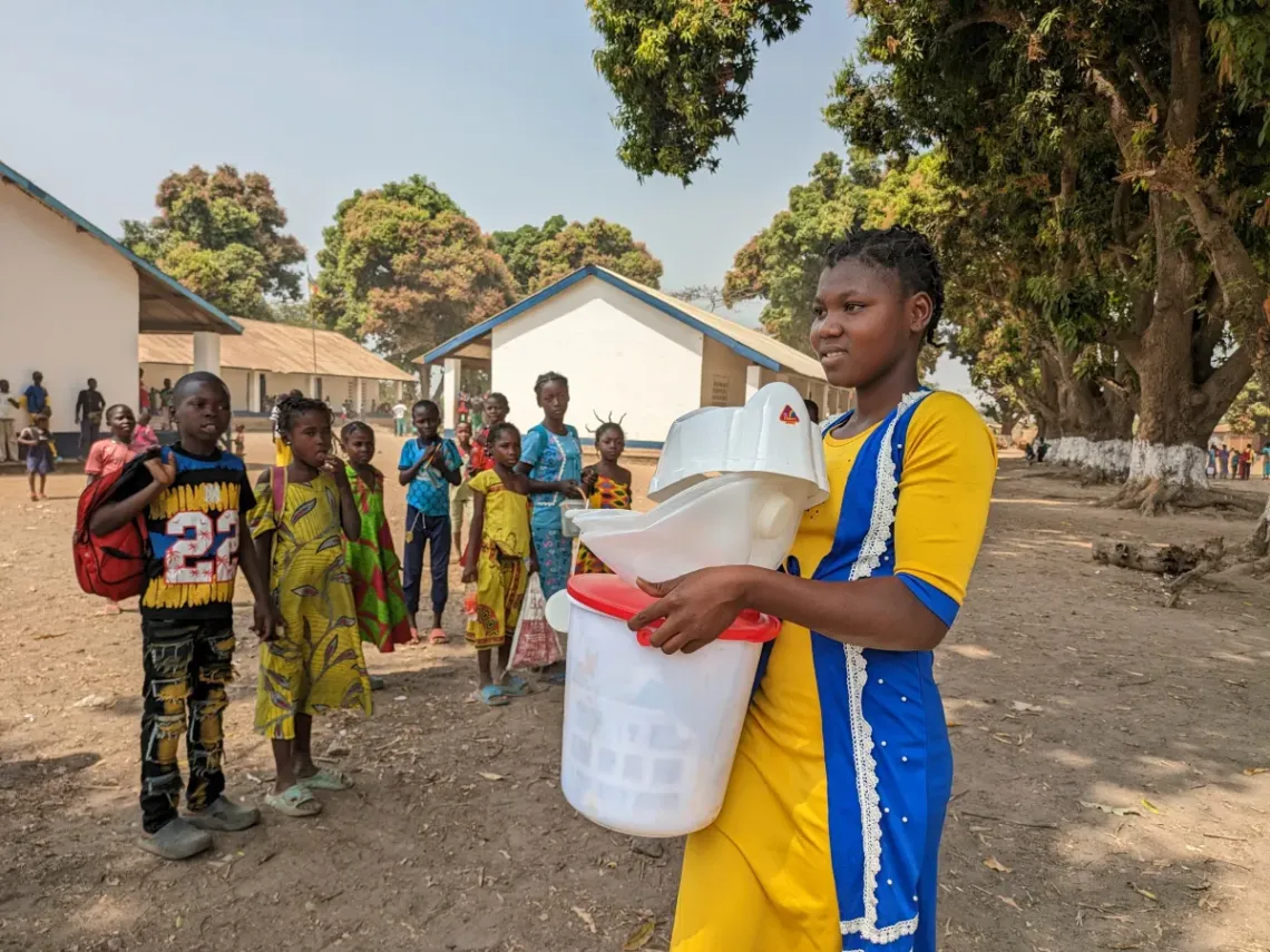 Elda Hasambo goes back home with her hygiene kit. 
