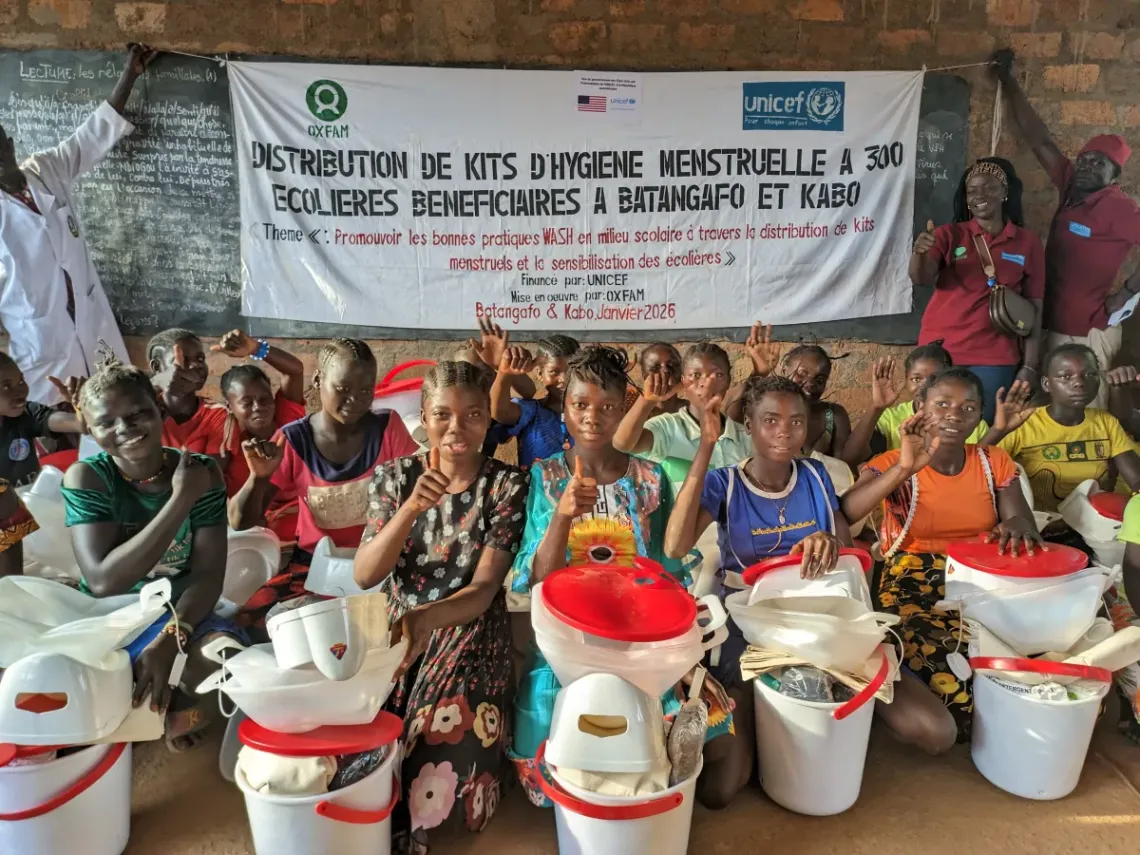 Clarisse Kembiyamgue, coordinator of the hygiene programme for girls in the Ouham Fafa, poses for a picture with students from the Baga primary school, in Batanfago