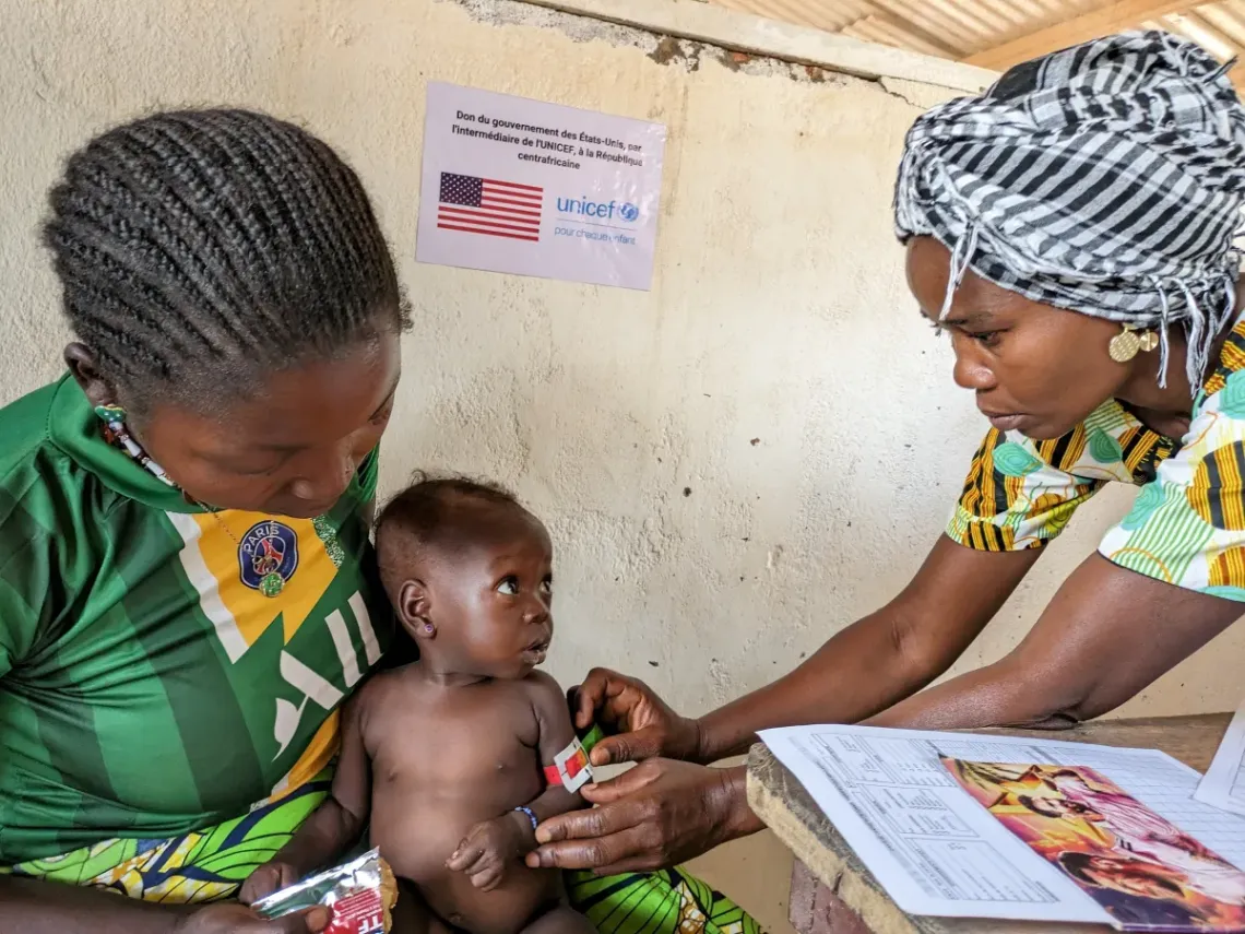 Nurse Judith Lamery measures the brachial circumference of 8-month baby Daniella