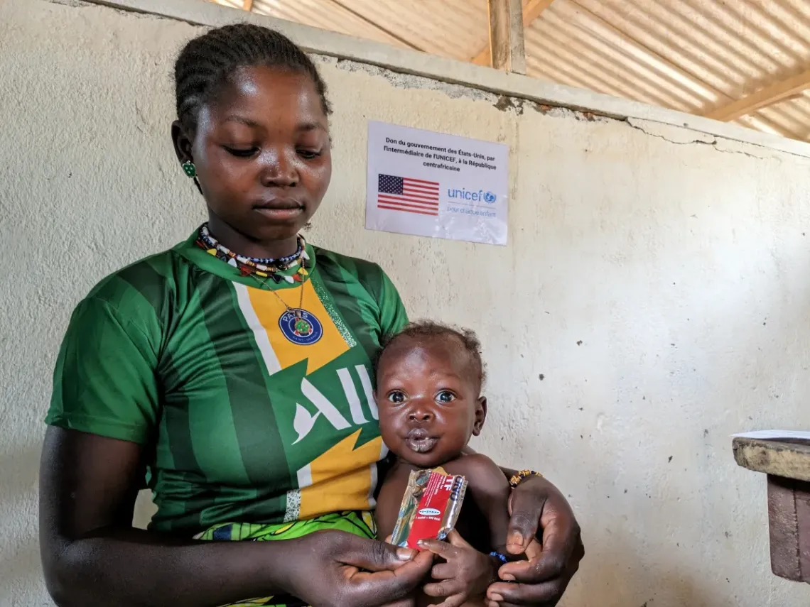 Daniella&rsquo;s mother, Marlene, gives her a sachet of ready-to-use-therapeutic food used as treatment for malnourished children.  