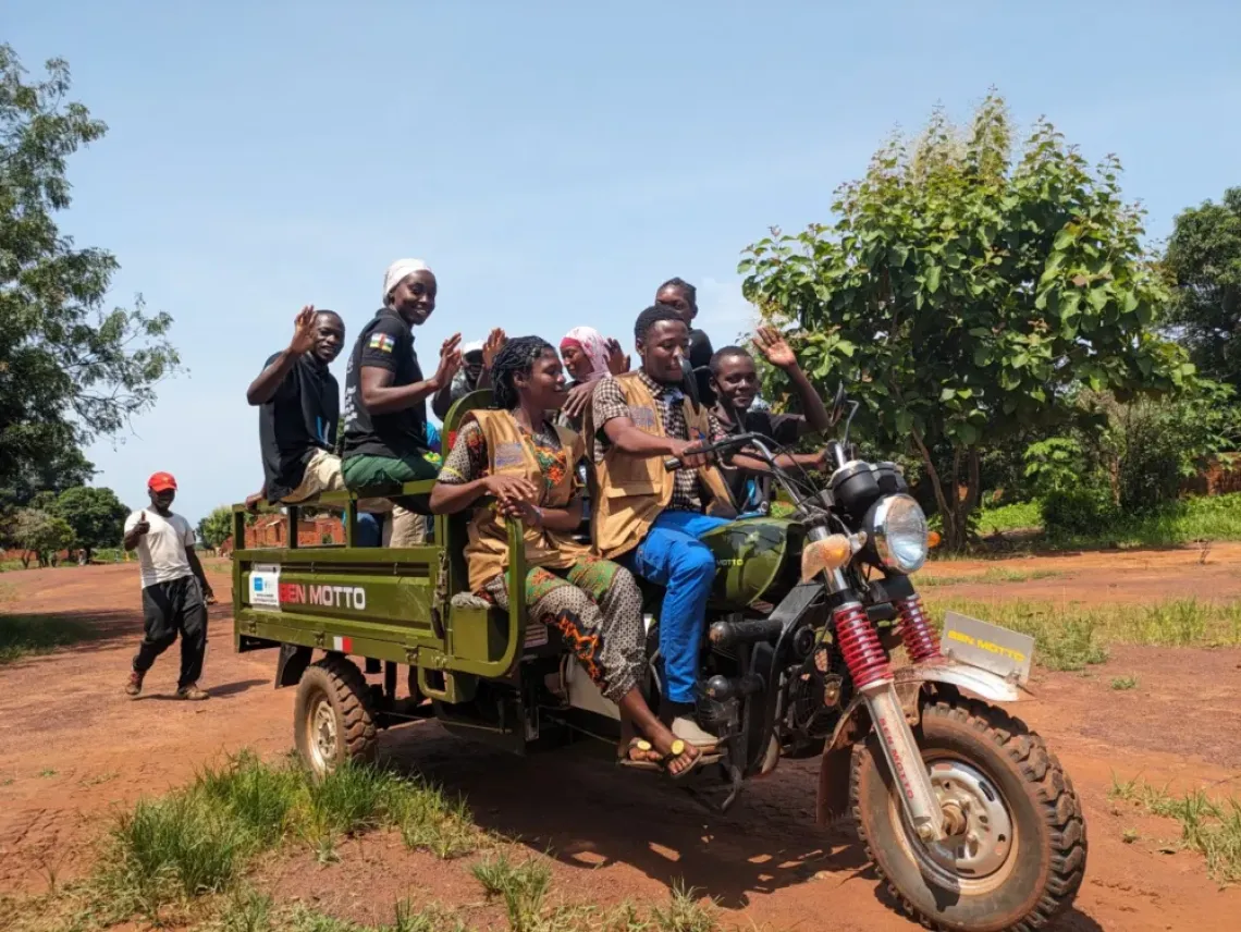 The U-Reporters team arrive in Koumboli village atop their tricycle, ready to meet their inhabitants and listen to their concerns