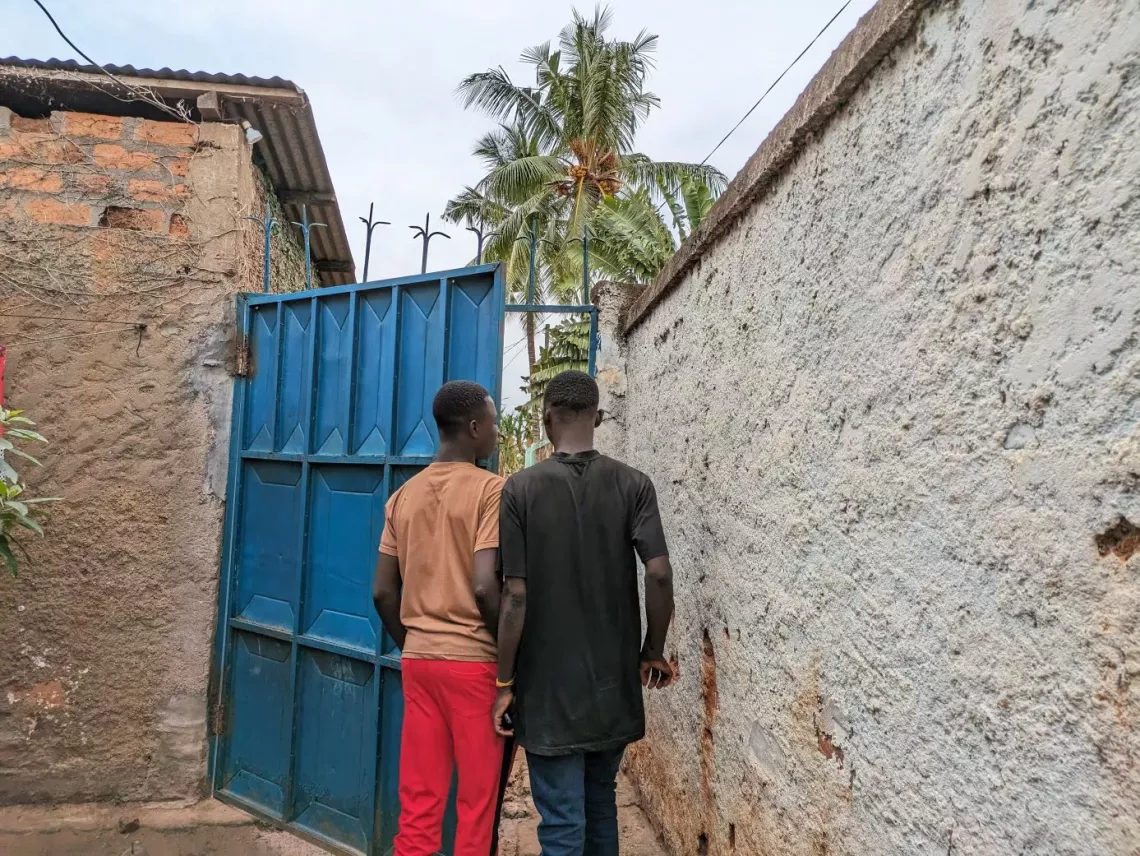 Philippe et Tony entrent dans la maison de leur famille d'accueil &agrave; Bangui
