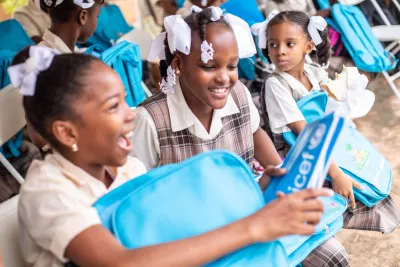 Children receiving their schoolbags at the first day of the school