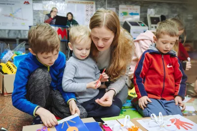 A female volunteer embracing a child.