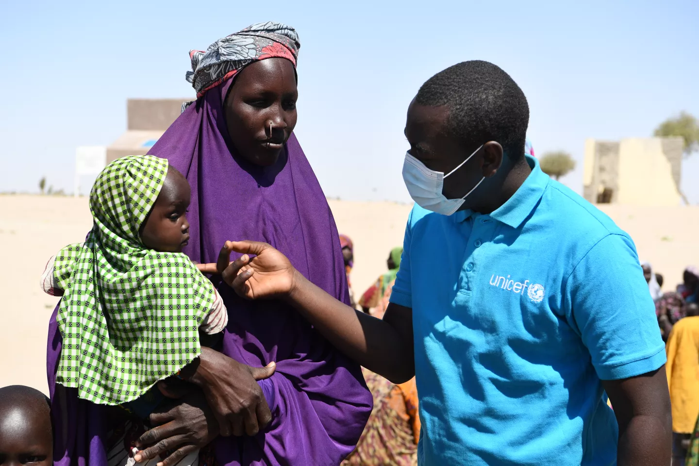 Annadjib Ramadane catching up with a woman and children at the site in the West of Chad.