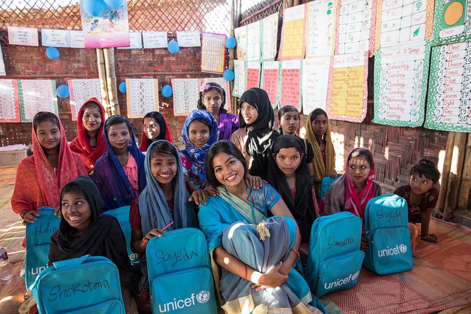 A UNICEF employee with refugee children