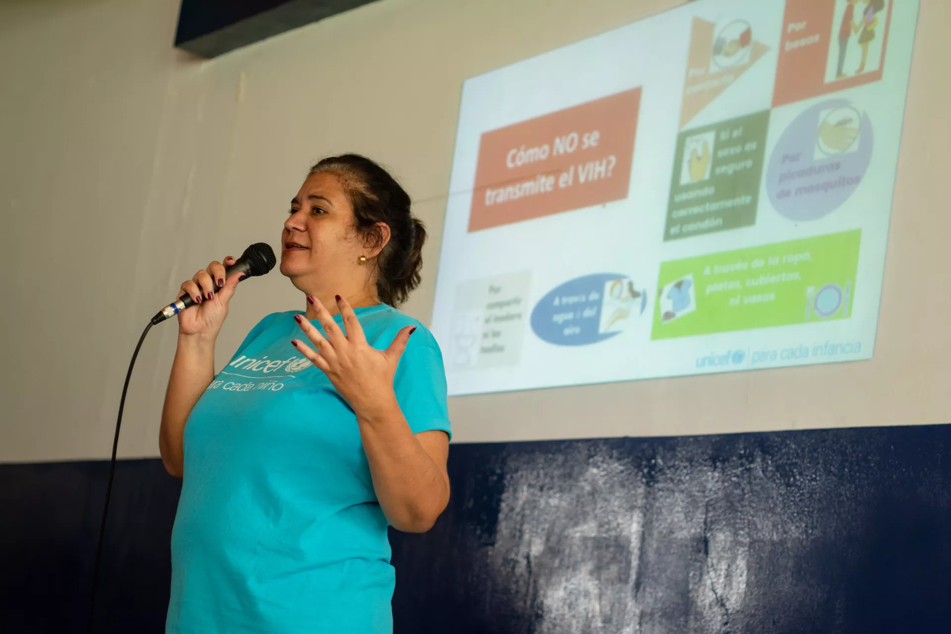 Una mujer sosteniendo un micr&oacute;fono dando un discurso