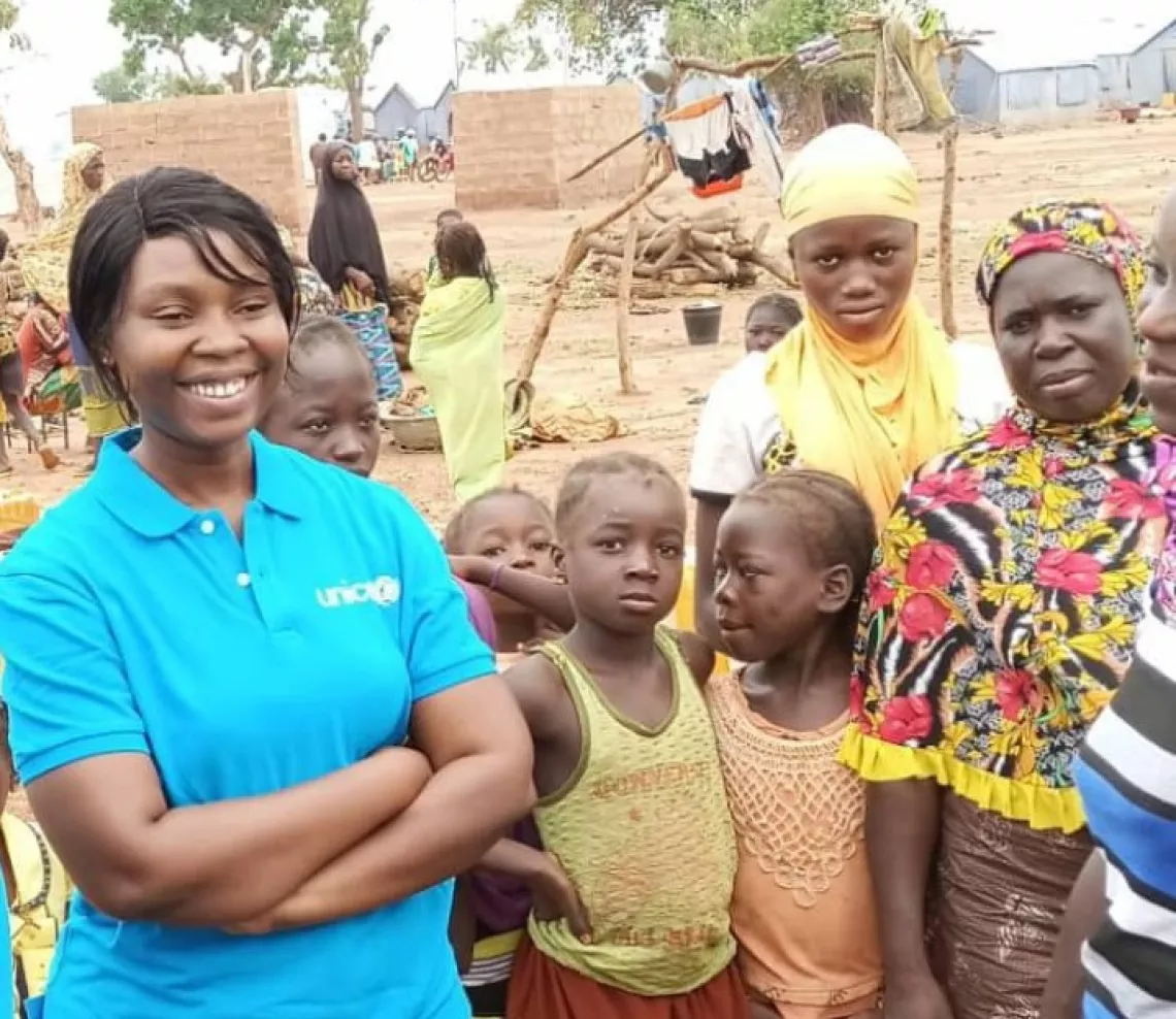 Aminata with children in the field