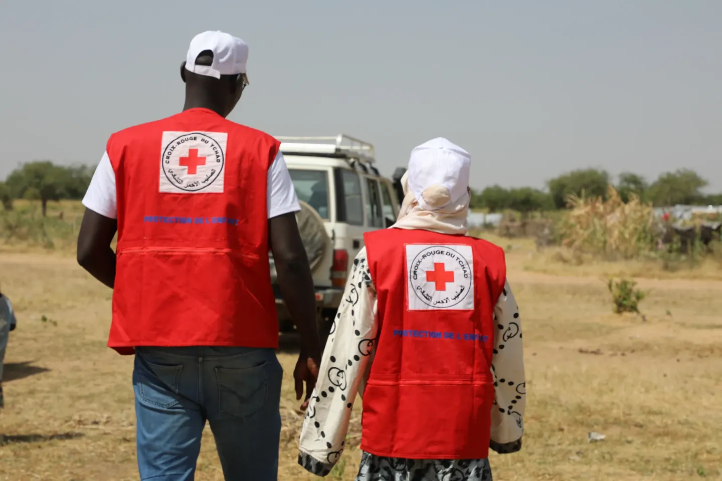 Issa Mahamat Issa, a child protection caseworker, and Zara Yasmine Adoum Ali, a caseworker specializing in gender-based violence, walk slowly under the sun. Notebook in hand, they stop from home to home, checking in on families, talking with adults, and listening to children. For the past three months, Issa has been working in the camp to support children and families affected by the disease.