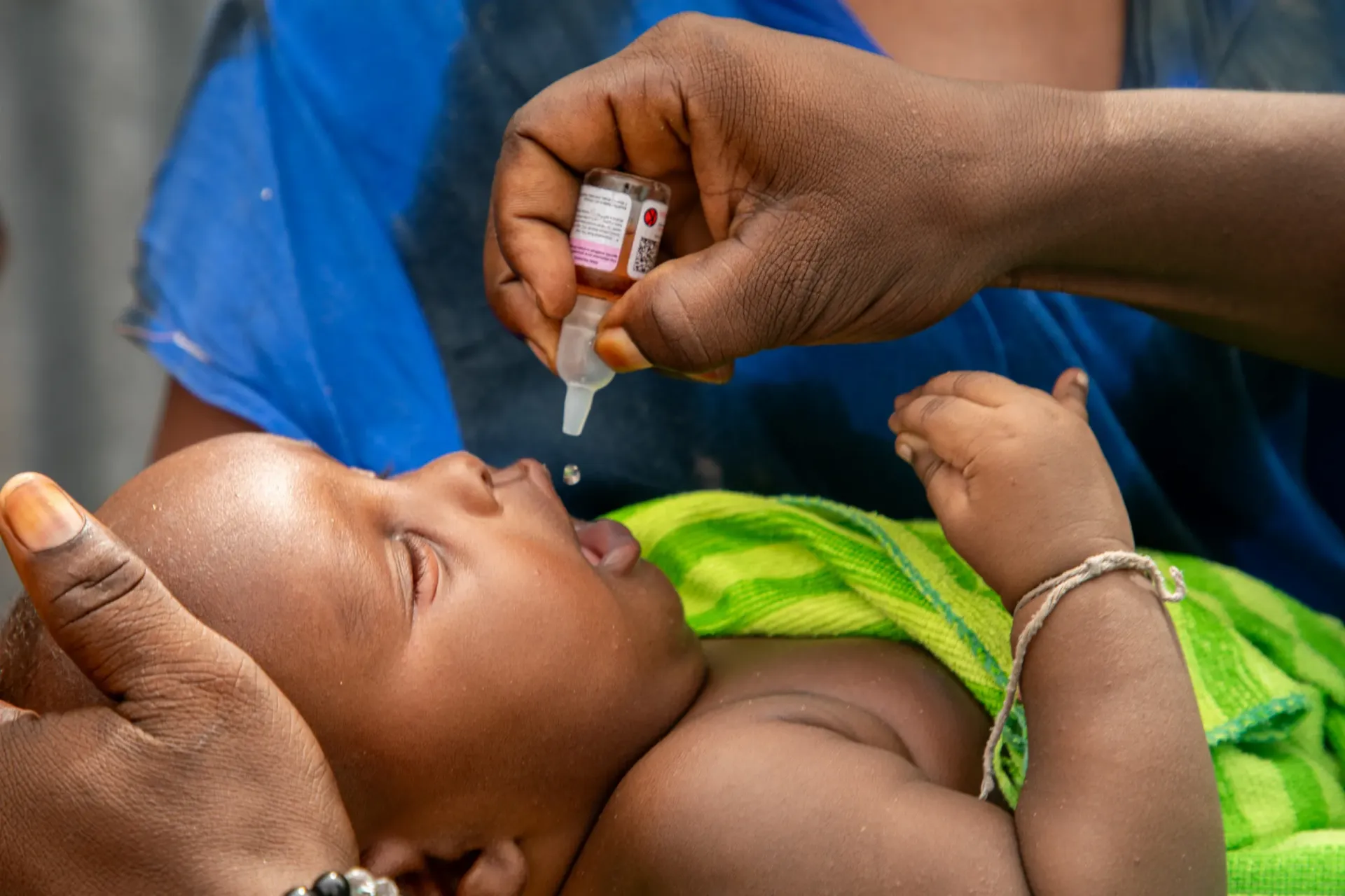 A baby receives a polio vaccine.