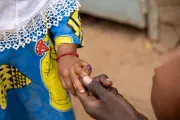 Amahani, 2 years old, receives a polio vaccine, a dose of vitamin A, and an albendazole tablet for deworming.