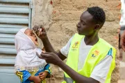 Amahani, 2 years old, receives a polio vaccine, a dose of vitamin A, and an albendazole tablet for deworming.