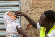 Amahani, 2 years old, receives a polio vaccine, a dose of vitamin A, and an albendazole tablet for deworming.