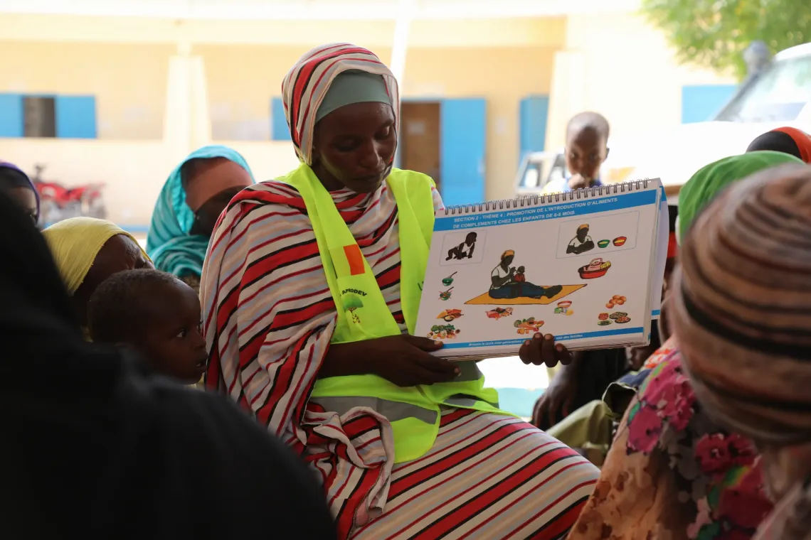 Alongside Zara, another community volunteer answers mothers' questions and shares practical advice on how to prevent malnutrition.