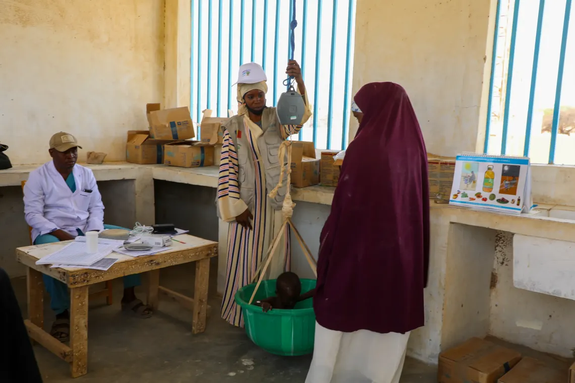 Mahamat is weighed to help health workers assess his nutritional status and determine the most appropriate treatment.