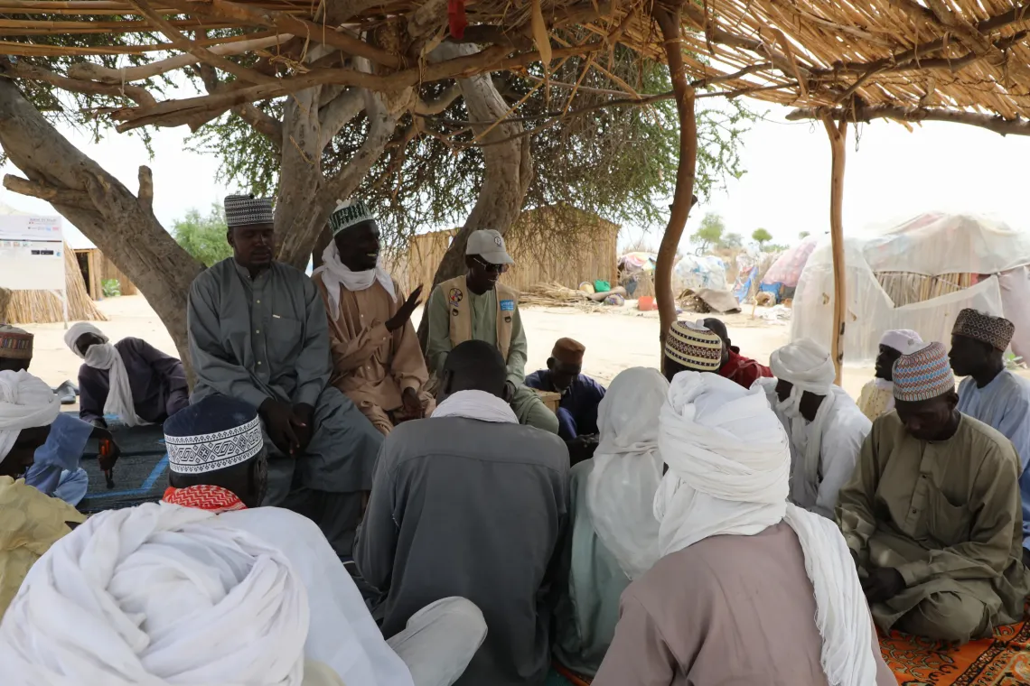 Community members discuss good hygiene and sanitation practices.