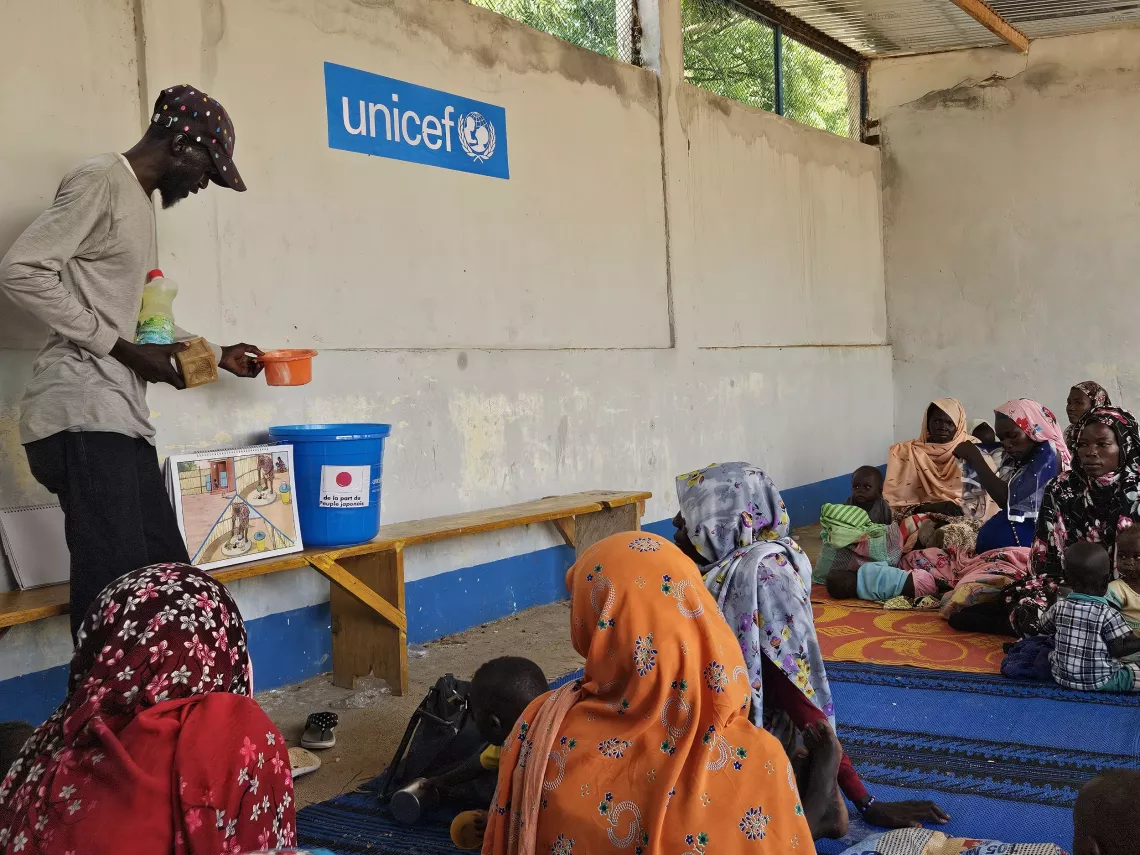 A community health worker leads a training session on good hygiene practices before distributing the kits.