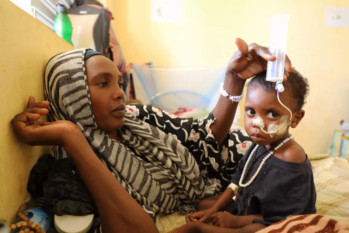 Mariam Mahamaden feeding her son Mourshid through a feeding tube.