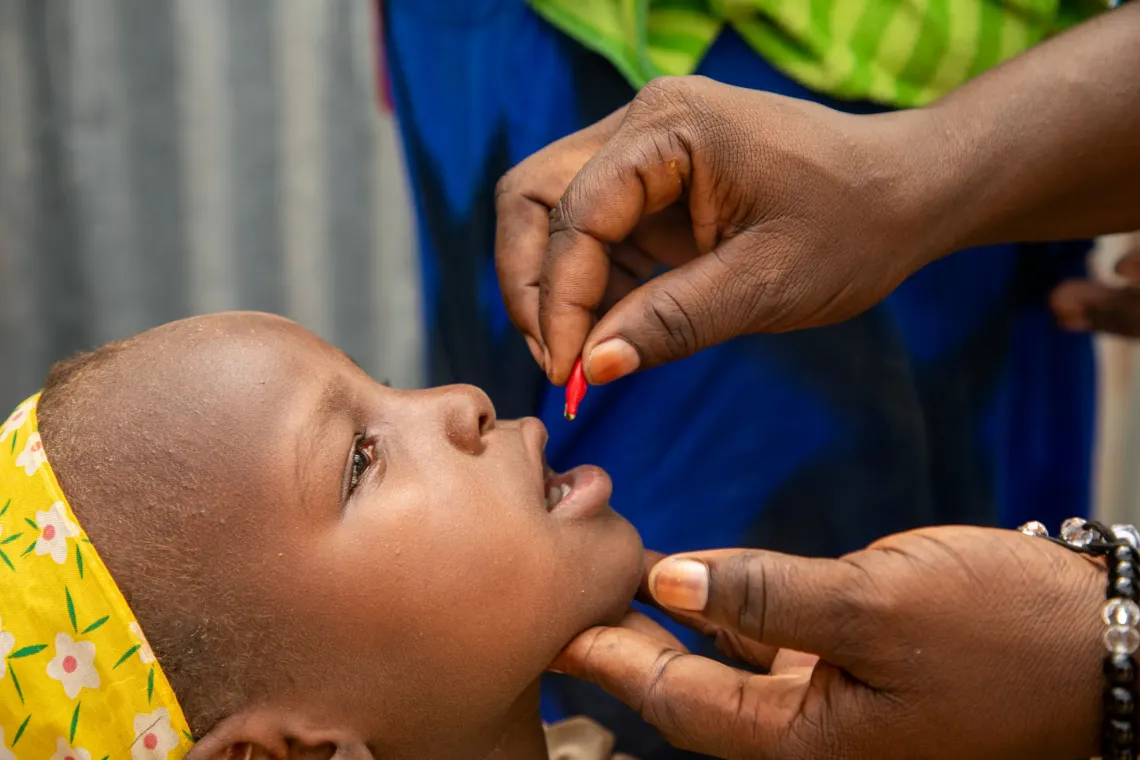 A girl receives vitamin A supplementation.