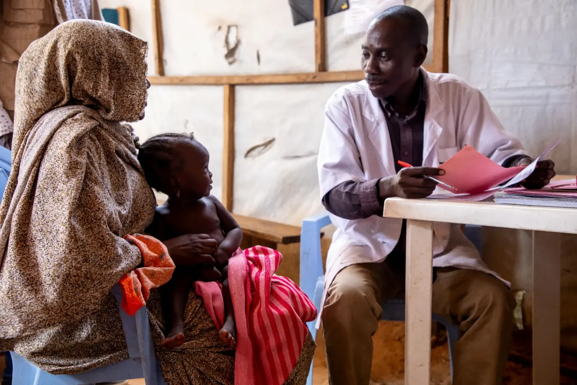 The consultation begins for Mahaza. Alim&eacute; answers a series of questions asked by the health worker.