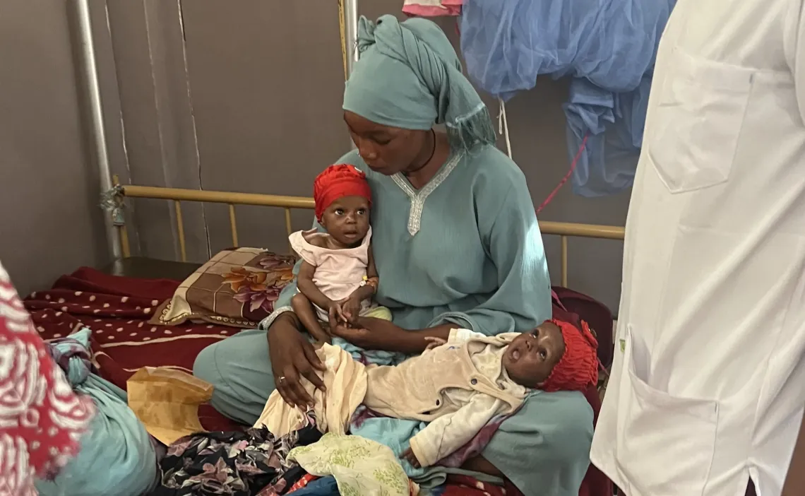 At the hospital, Kaltouma cradles Haoua and Zenaba as they receive the essential medical care and nutritional support needed for their recovery.