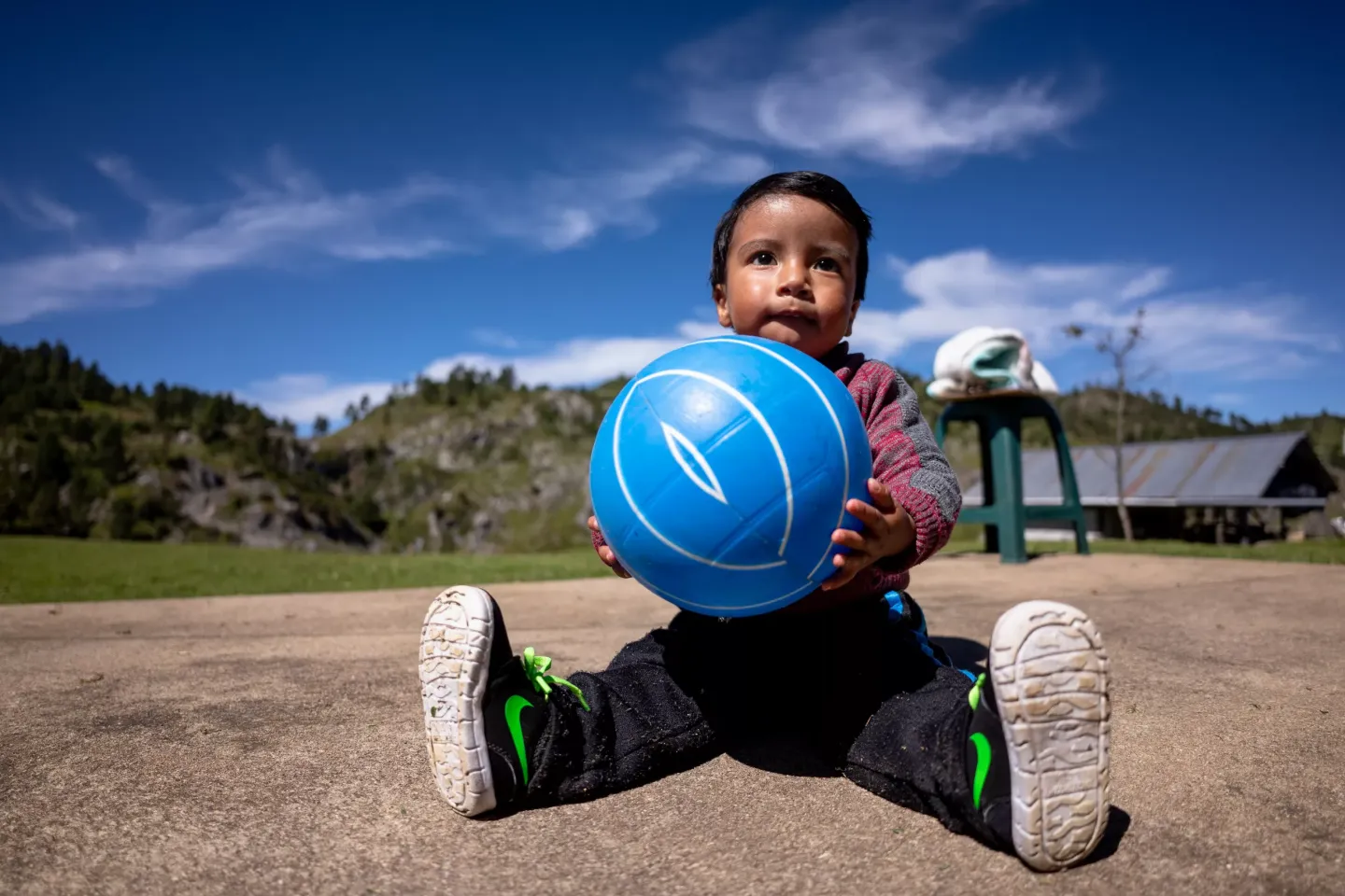 Erick Samuel -- 18 months old -- holds the ball he plays with in the patio of his home in the village of Tunim&aacute; Charchales in Chiantla, Huehuetenango