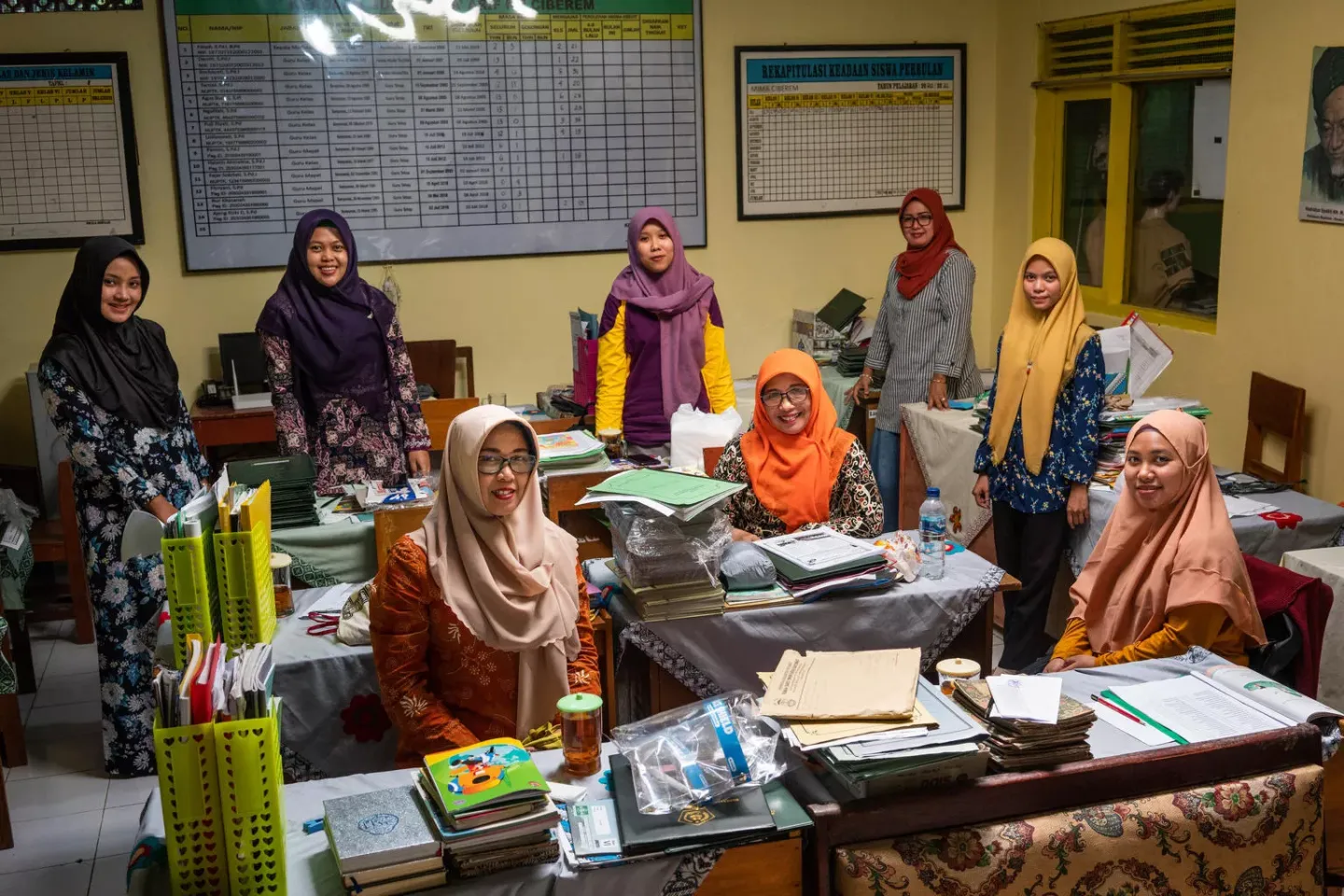 Teachers pose in an office at Madrasah Ibtidaiyah (MI) 1 Ciberem in Banyumas, Central Java, Indonesia