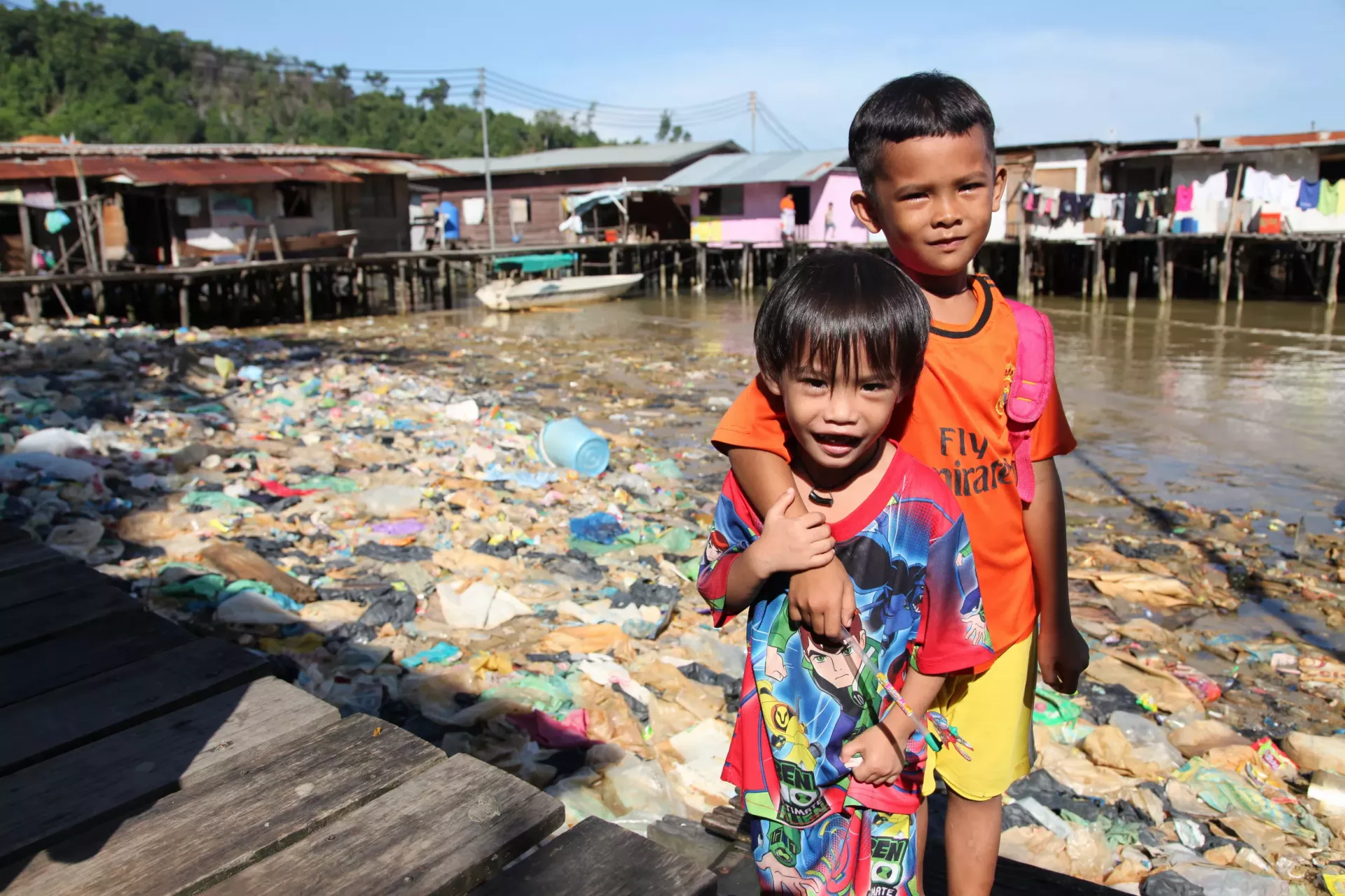 Children playing near a rubble of waste is not an uncommon sight in this village built above water off the coast of Sabah, East Malaysia.