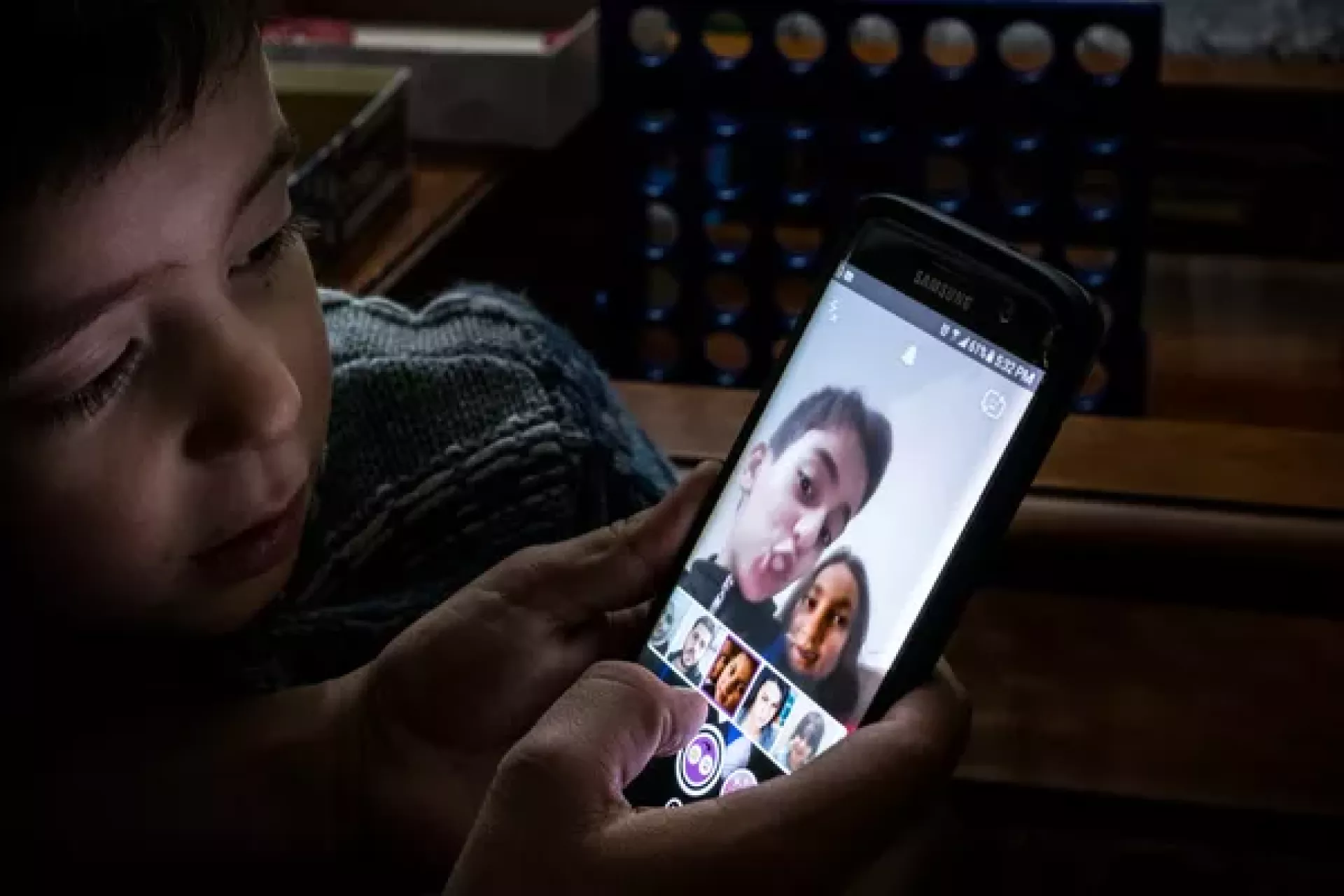 Basel Al Rashdan, 11, Shatha Al Rashdan, 7, and Idress Al Rashdan, 5, play with snapchat filters on their mothers phone at home