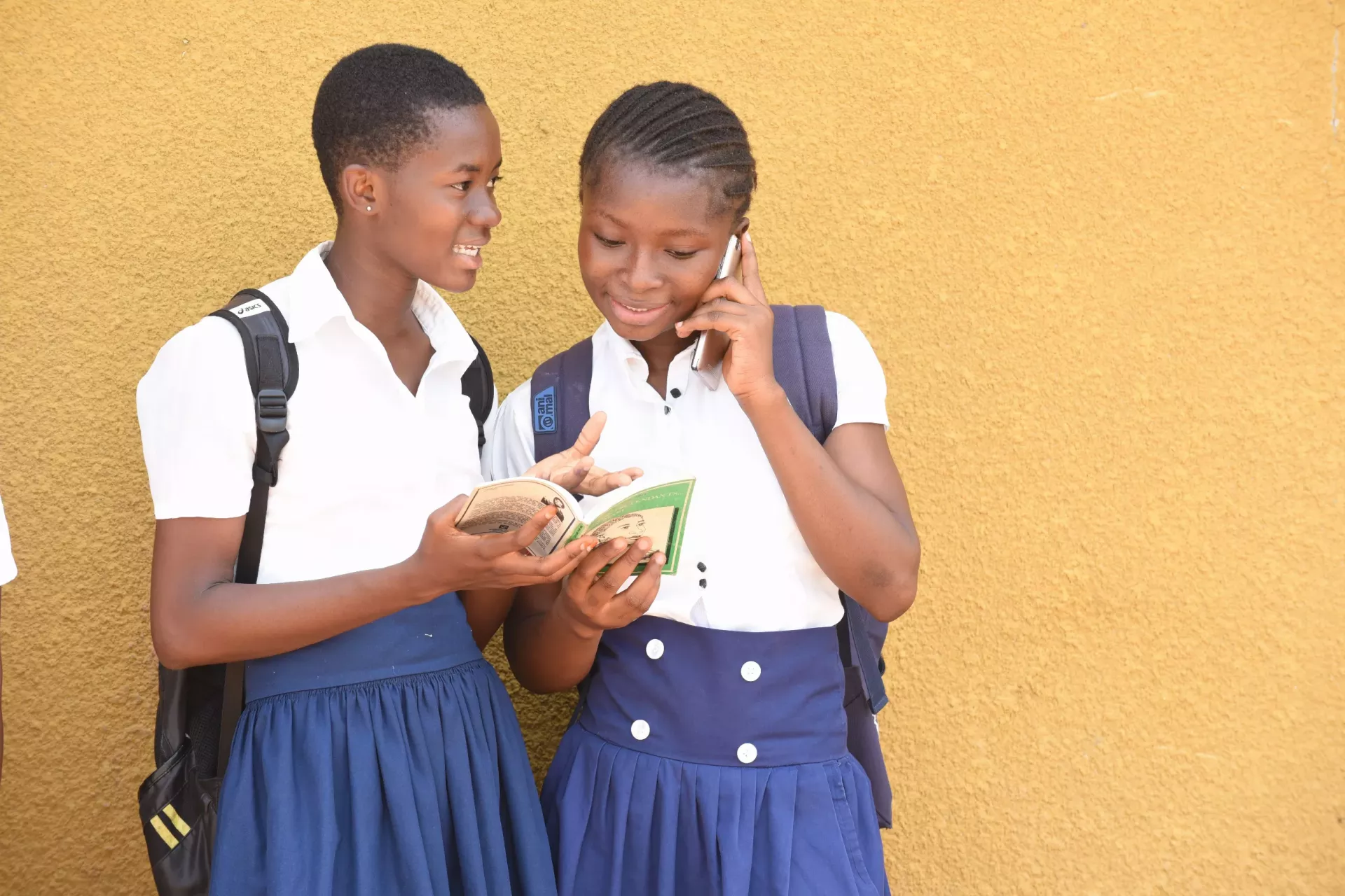 Teenager girls using mobile phone in the town of Odienn&eacute; in the northwest of C&ocirc;te d'Ivoire.