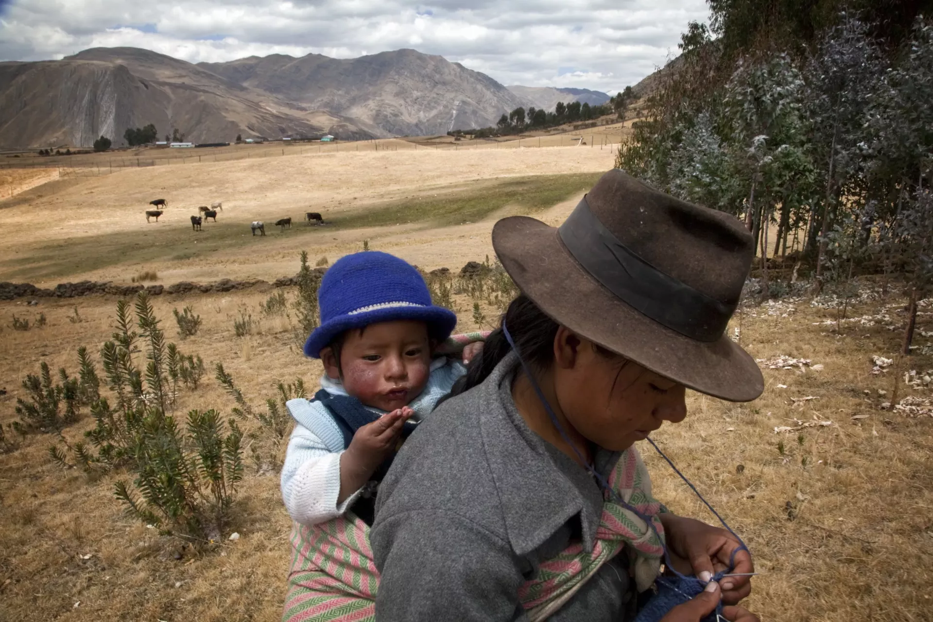 One-year-old Luis and his mother, Maria Broncano Mejia, return to their farmhouse in Llacuash, a remote farming community in the district of Huallanca.