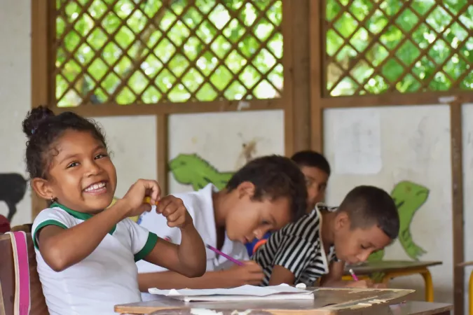 A girl and three boys study in a classroom 