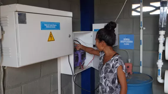 Mujer ind&iacute;gena manejando el sistema de agua