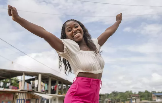 Adolescente sonriendo estirando sus brazos 
