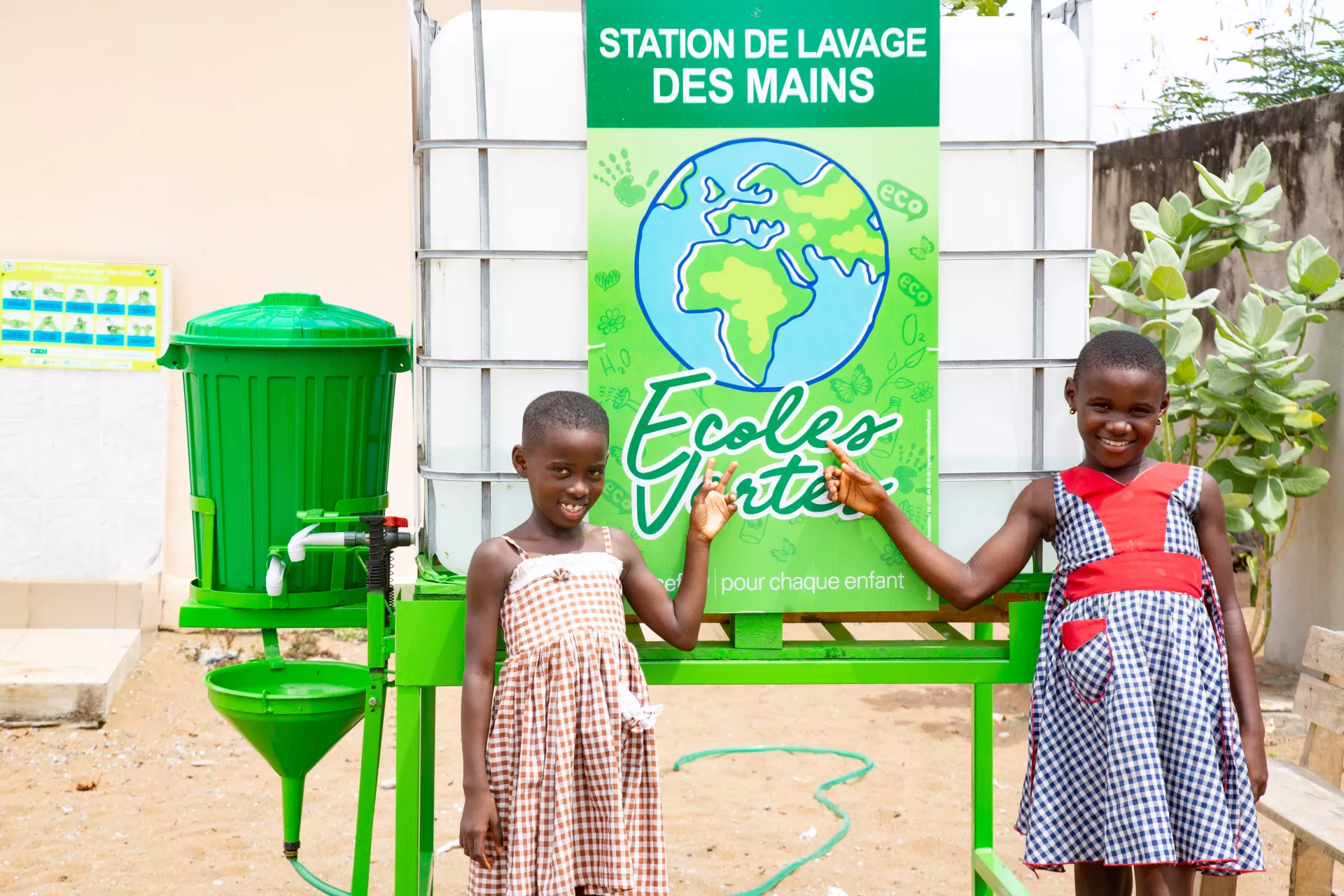 Children in front of the handwashing facility installed in their school as part of the Green Schools project.