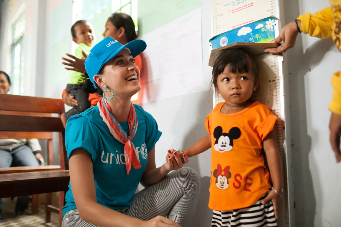 26. svibnja 2016. u Vijetnamu, ambasadorica dobre volje UNICEF-a Katy Perry pomaže u mjerenje visine djeteta u općinskom zdravstvenom centru Phuoc Thanh u provinciji Ninh Thuan.